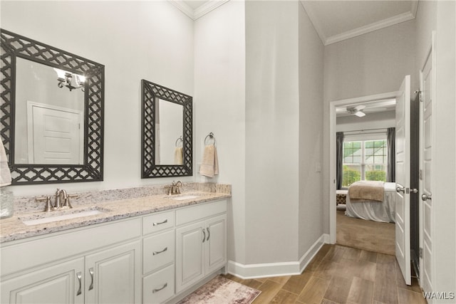 bathroom with crown molding, vanity, wood-type flooring, and ceiling fan