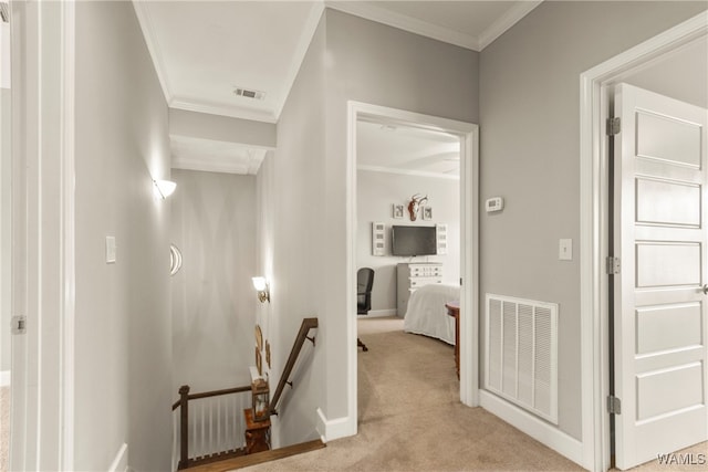 corridor with light carpet and crown molding