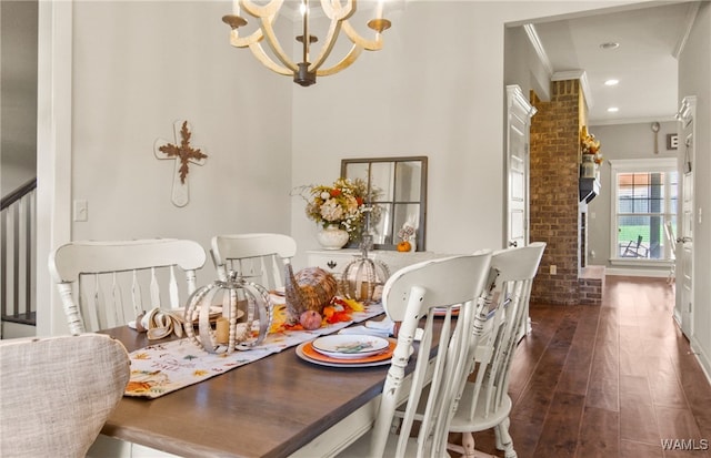 dining space with a notable chandelier, dark hardwood / wood-style floors, crown molding, and brick wall