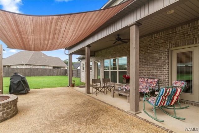 view of patio featuring grilling area, an outdoor fire pit, and ceiling fan