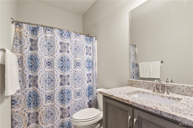 bathroom with a shower with curtain, vanity, and toilet