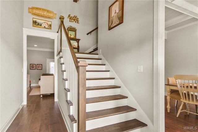 staircase with hardwood / wood-style flooring and crown molding