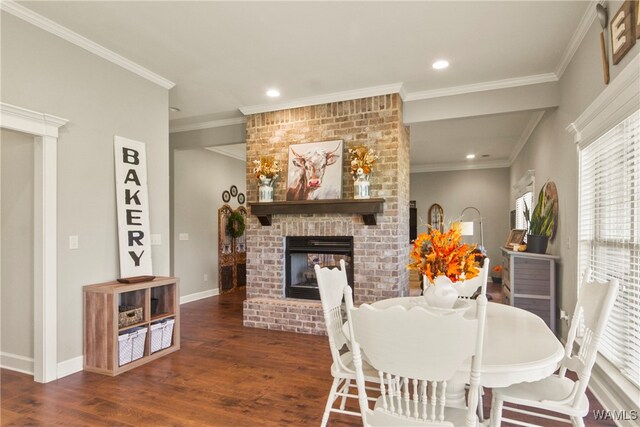 dining room featuring a fireplace, crown molding, and dark hardwood / wood-style flooring