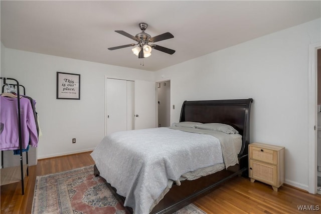 bedroom featuring ceiling fan, hardwood / wood-style floors, and a closet