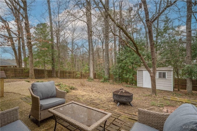 view of patio with a storage unit and an outdoor fire pit