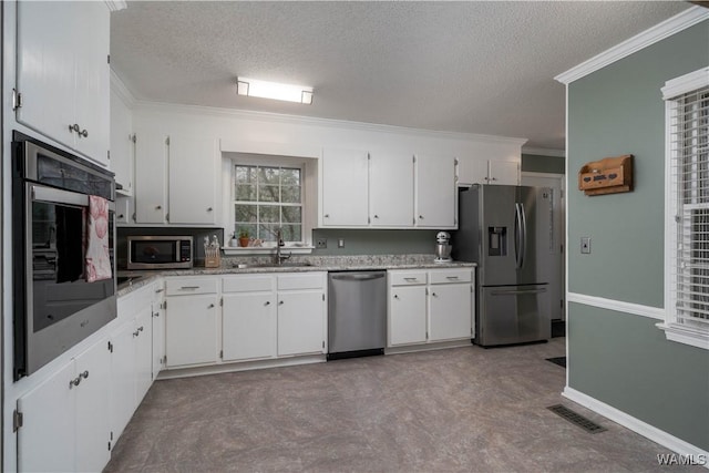 kitchen with white cabinetry, sink, crown molding, and appliances with stainless steel finishes