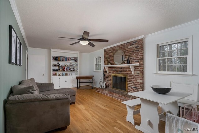 living room with crown molding, a textured ceiling, and hardwood / wood-style flooring