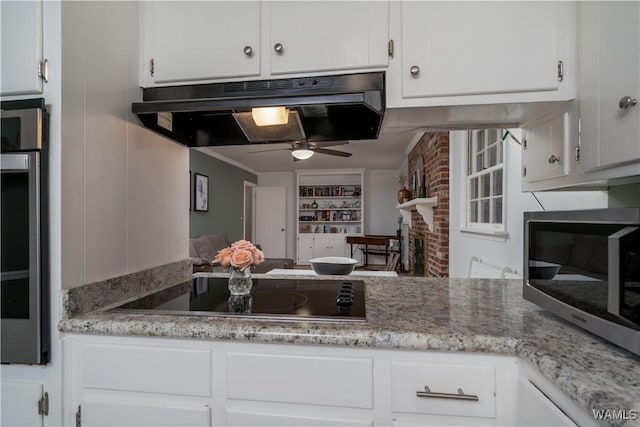 kitchen featuring white cabinetry, appliances with stainless steel finishes, and extractor fan