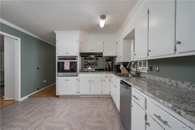 kitchen featuring crown molding, stainless steel appliances, sink, and white cabinets