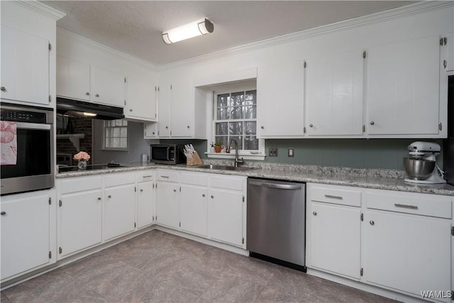 kitchen featuring ornamental molding, appliances with stainless steel finishes, sink, and white cabinets