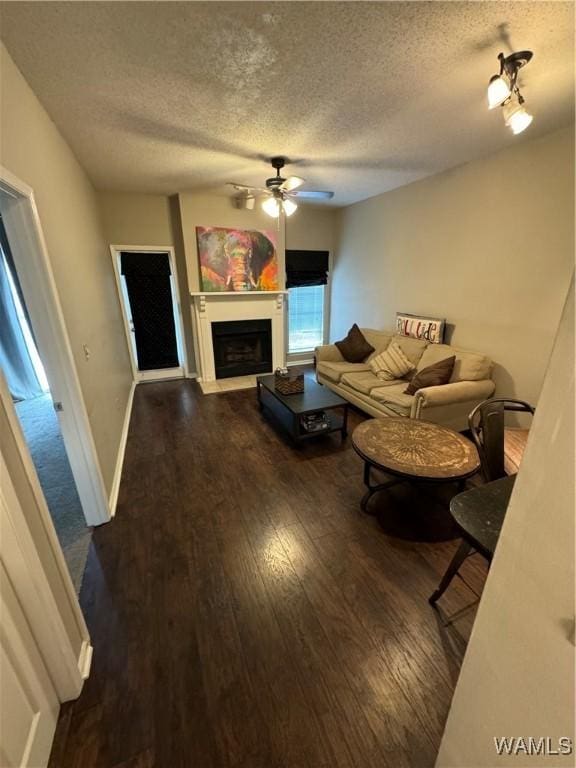 708 11th St Unit 226, Tuscaloosa, AL 35401 - living area with a textured ceiling, ceiling fan, wood finished floors, and a fireplace