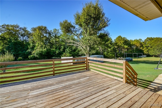 wooden deck featuring a lawn