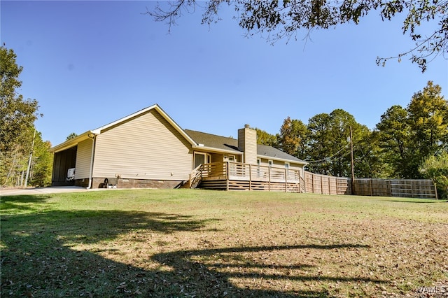 back of house with a lawn and a wooden deck