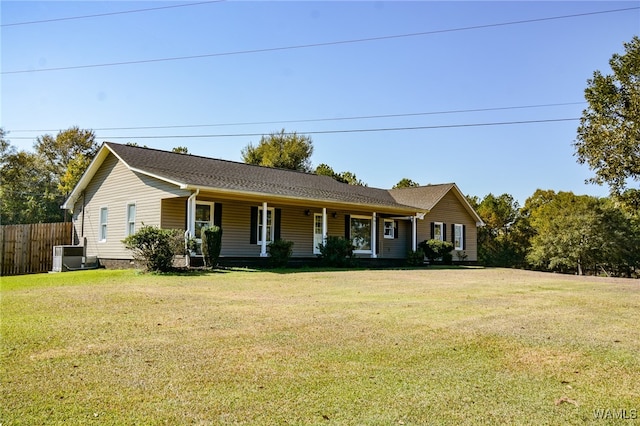 single story home with covered porch, central air condition unit, and a front yard