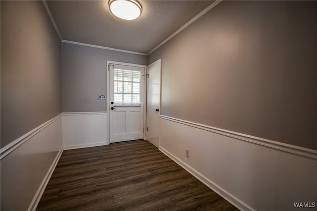 entryway with a textured ceiling, dark hardwood / wood-style floors, and ornamental molding