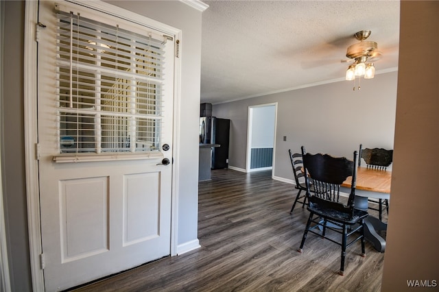 dining room featuring a textured ceiling, dark hardwood / wood-style floors, ceiling fan, and ornamental molding