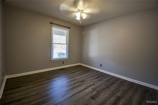 unfurnished room featuring ceiling fan, dark hardwood / wood-style flooring, and a textured ceiling