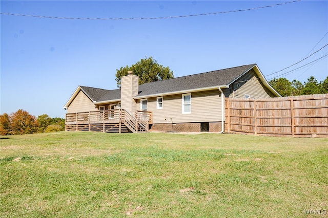 back of house with a lawn and a deck