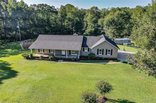 ranch-style home with a front lawn and covered porch