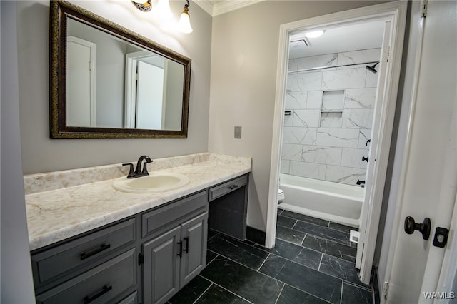 full bathroom with vanity, toilet, ornamental molding, and tiled shower / bath combo