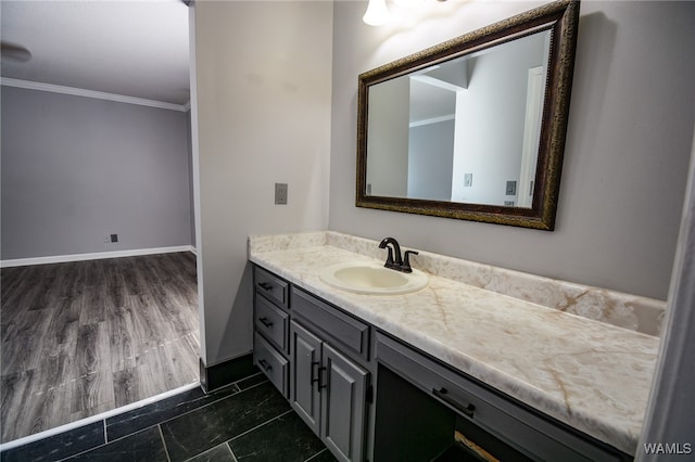 bathroom featuring hardwood / wood-style flooring, vanity, and ornamental molding