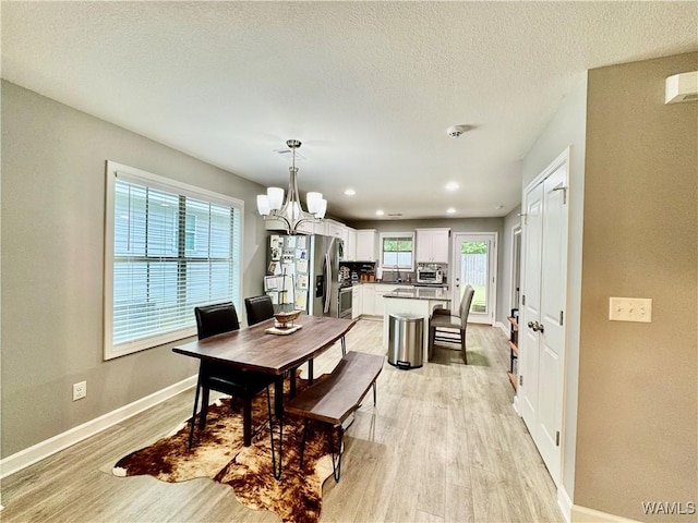 6643 Cooperstown Cir, Tuscaloosa, AL 35453 - dining space with a chandelier, light wood-style flooring, baseboards, recessed lighting, and a textured ceiling