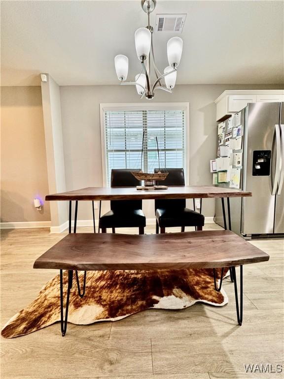6643 Cooperstown Cir, Tuscaloosa, AL 35453 - dining room featuring a chandelier, light wood-style flooring, and baseboards