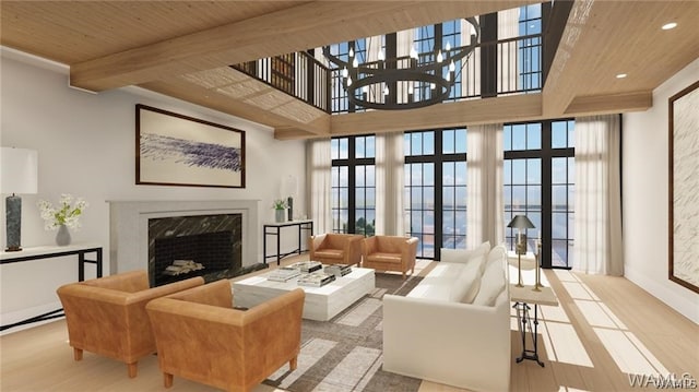 living room with a high end fireplace, french doors, light wood-type flooring, a towering ceiling, and wooden ceiling