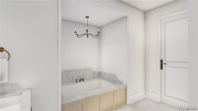 bathroom featuring an inviting chandelier and a bathing tub