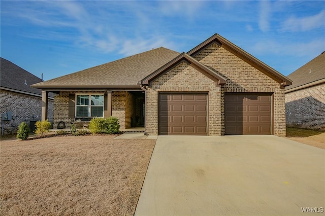 view of front of house featuring brick siding, driveway, an attached garage, and roof with shingles