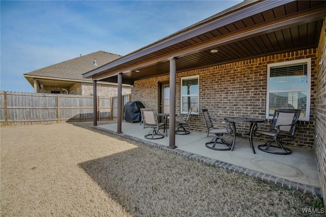 view of patio with fence and area for grilling