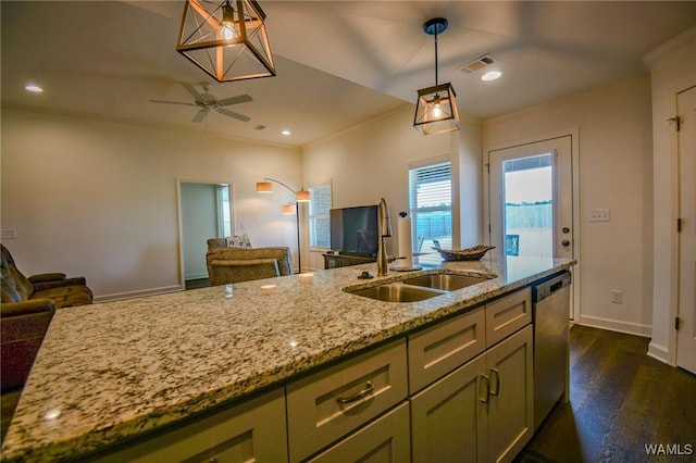 kitchen featuring dishwasher, open floor plan, a sink, and green cabinets