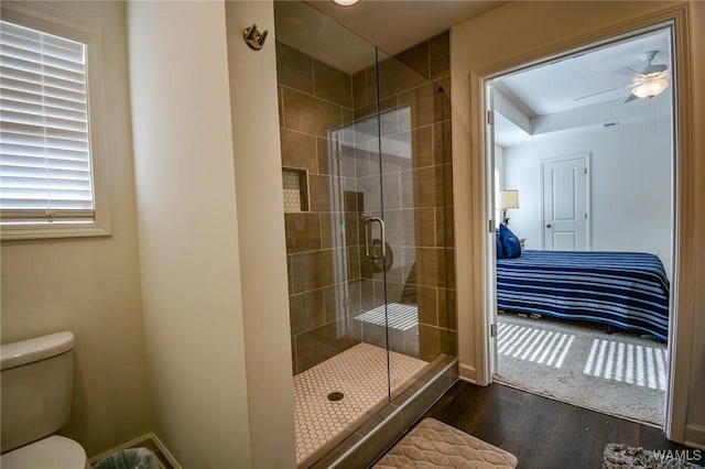 full bath featuring toilet, a shower stall, ensuite bath, and wood finished floors