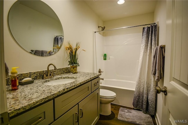 full bath featuring toilet, wood finished floors, shower / bath combination with curtain, and vanity