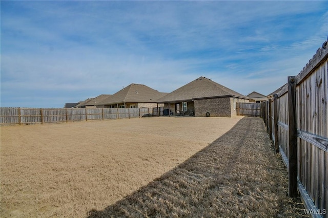 view of yard featuring a fenced backyard