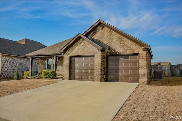 single story home with a shingled roof, concrete driveway, an attached garage, central air condition unit, and brick siding