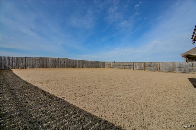 view of yard with a fenced backyard