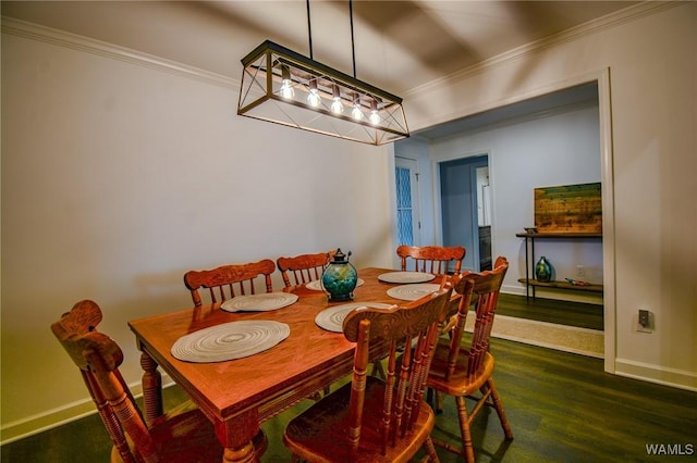 dining room with ornamental molding, dark wood finished floors, and baseboards