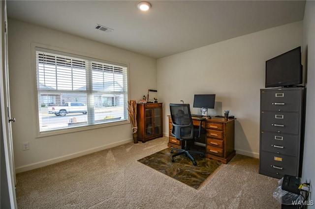 carpeted home office with baseboards and visible vents