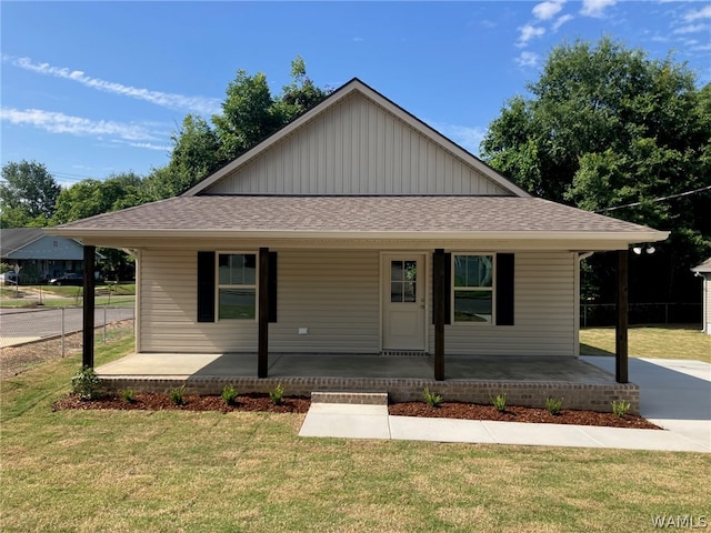 view of front of home with covered porch and a front yard