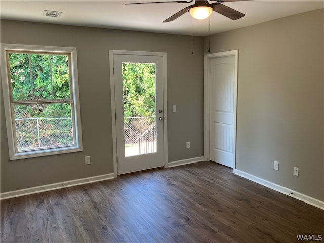 interior space featuring ceiling fan and dark wood-type flooring