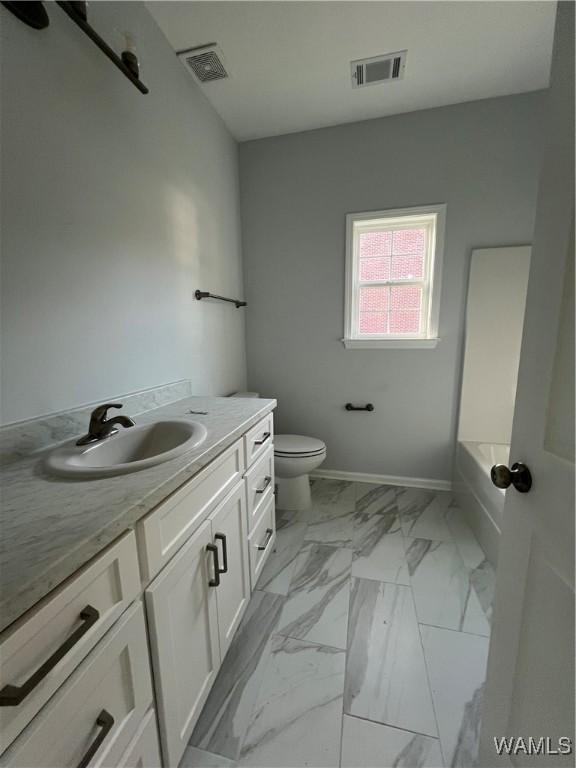 bathroom with vanity and toilet