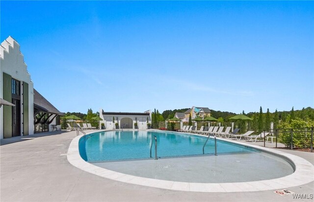 pool featuring a patio and fence