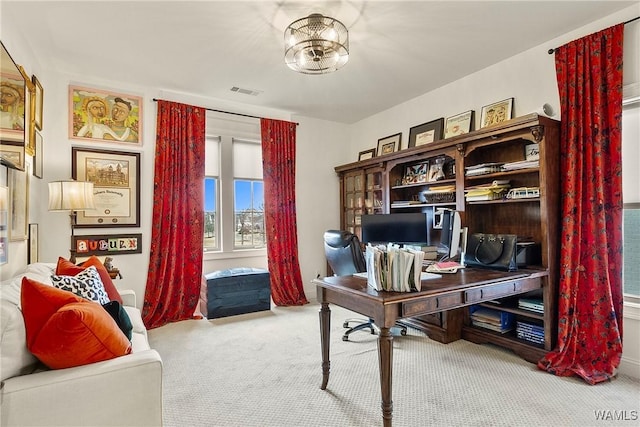 home office with a notable chandelier, carpet, and visible vents