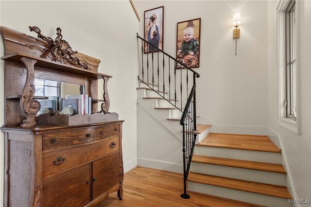 stairway featuring baseboards and wood finished floors