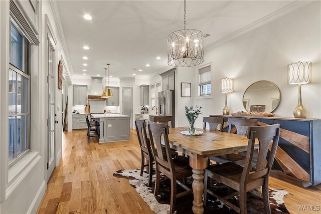 dining area featuring crown molding, recessed lighting, and light wood-type flooring