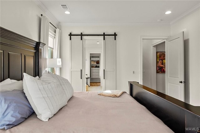 bedroom featuring visible vents, recessed lighting, crown molding, and a barn door