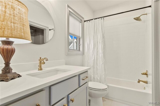 full bathroom featuring tile patterned floors, shower / tub combo, toilet, and vanity