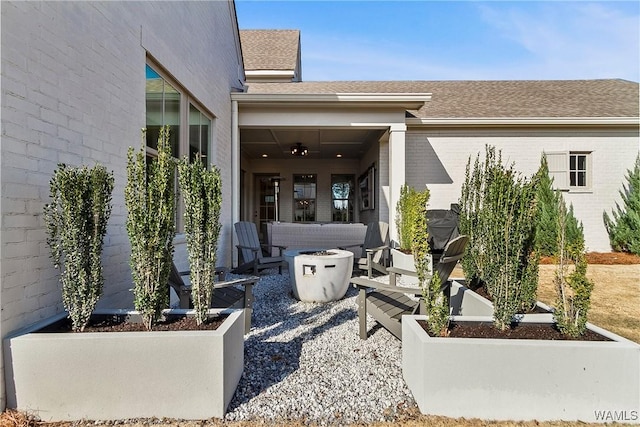 view of patio featuring an outdoor living space with a fire pit