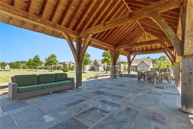 view of patio with outdoor dining space, a gazebo, and a residential view